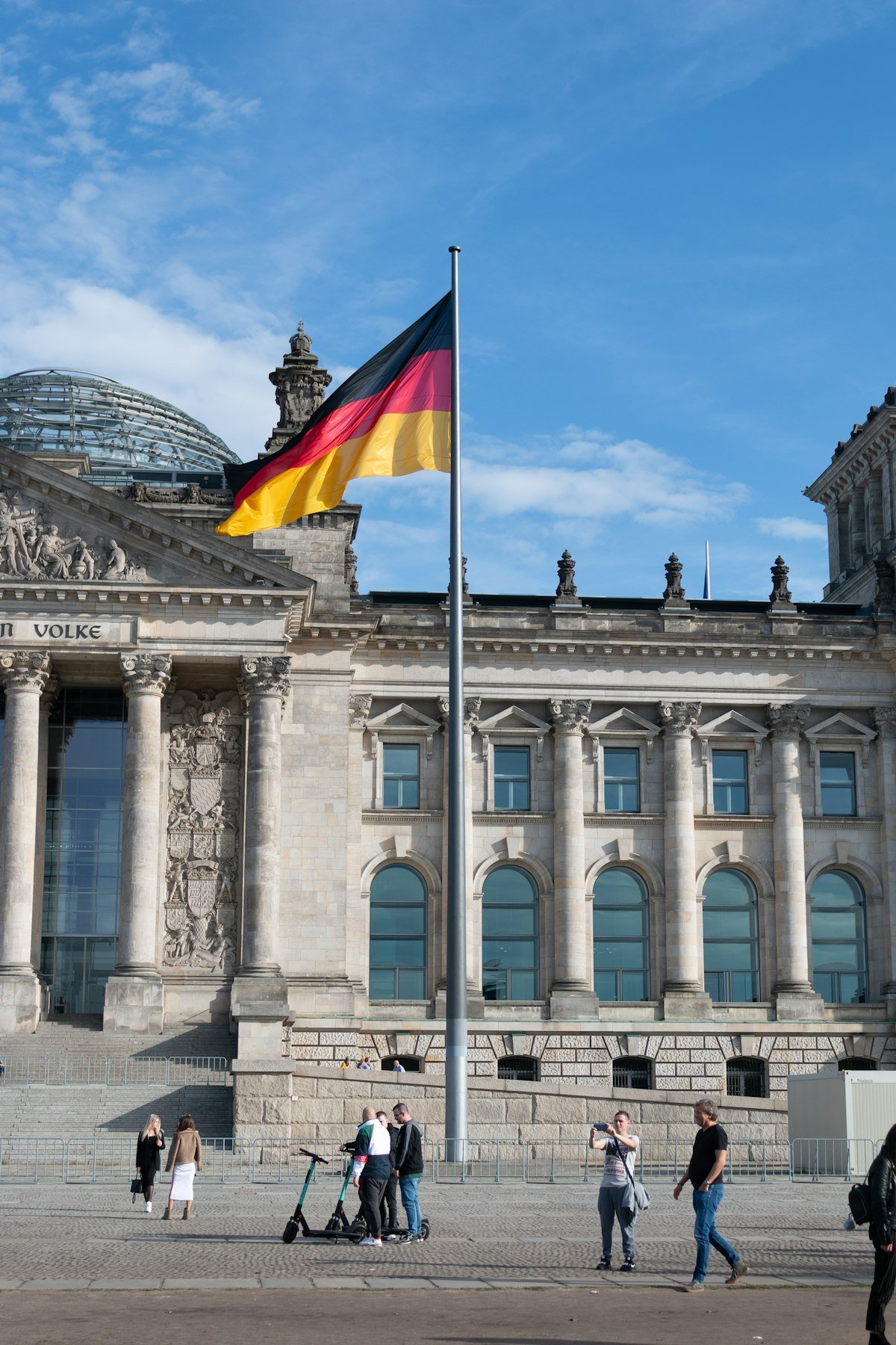 People walking near a German flag – student life in Germany for Indian students